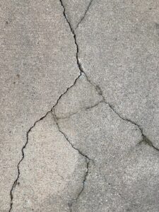 the crack in the concrete shows a crack in the road