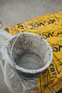 gray metal bucket on yellow paper